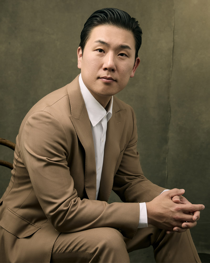 Dr. Gene K. Lee, MD, MPH of La Môem Plastic Surgery wearing a brown suit in Beverly Hills